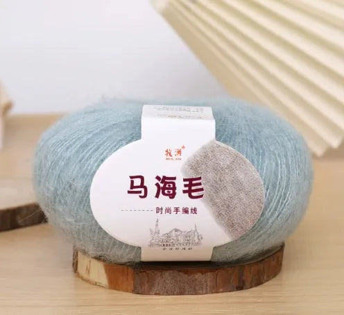 DIY mohair scarf weaving kit showing one wool ball and a selection of 34 colour options including white, pink, blue and green.