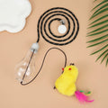 Gray and yellow hanging interactive cat toy with treat dispenser extended on elastic rope