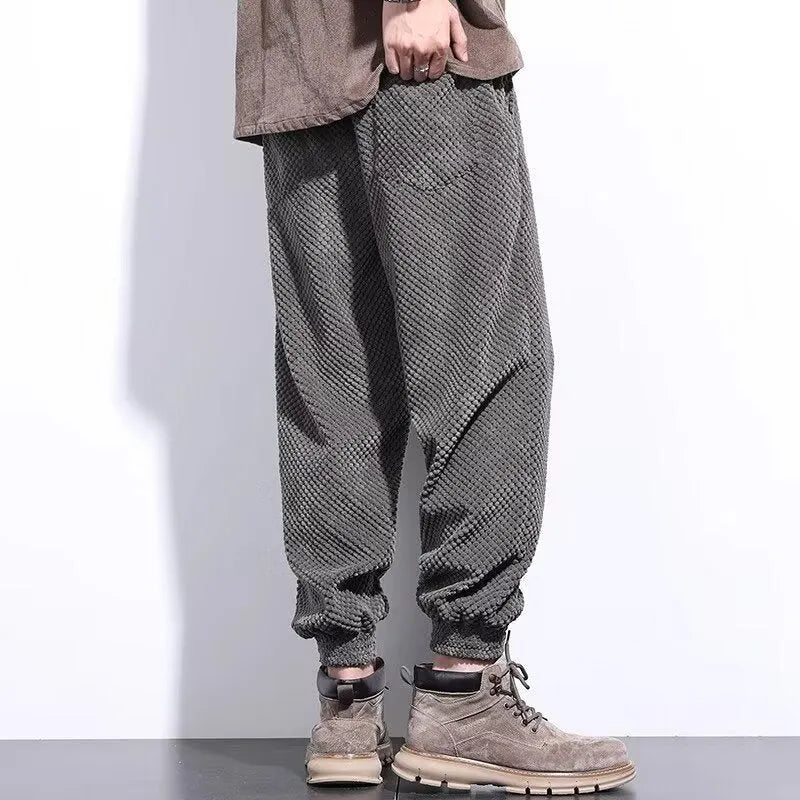 Men's grey straight-leg casual sweatpants with an ankle-tied design on a white background.