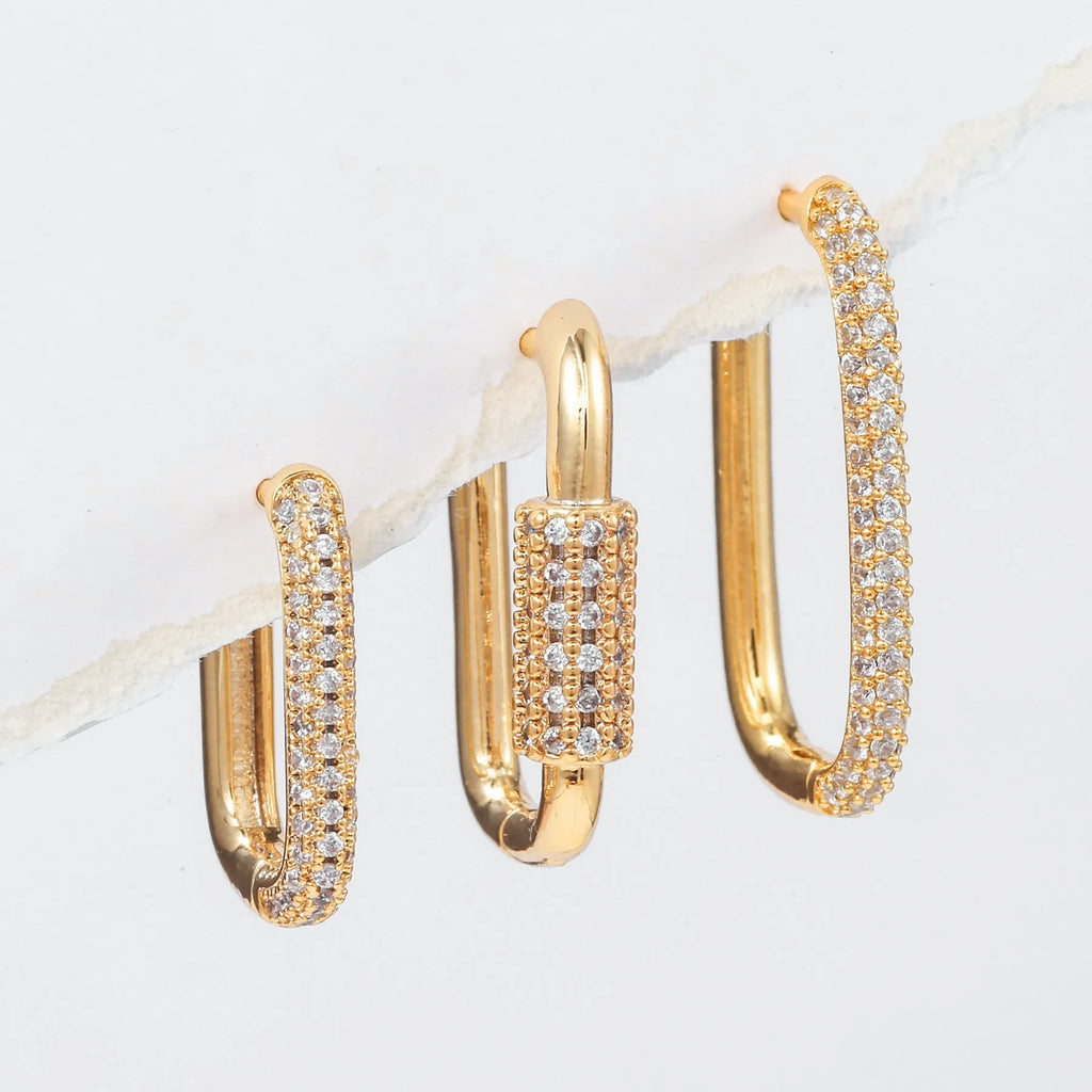 Three geometric copper earrings with zircon micro inlay in clip-on design showing ellipse and quadrilateral shapes