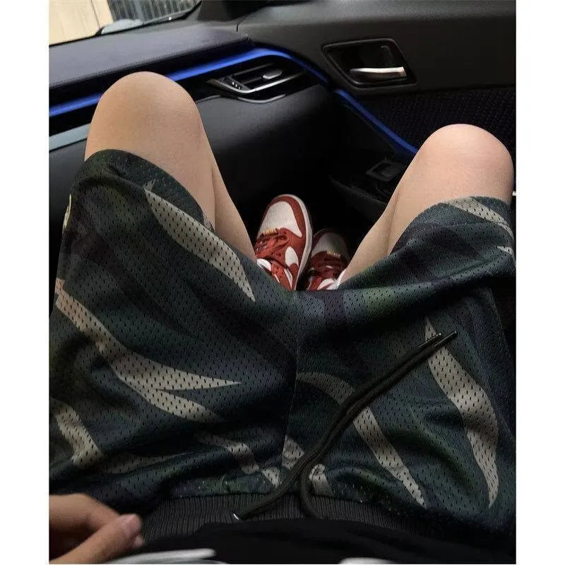 Men's camouflage pattern mesh shorts in cotton blend fabric showing straight cut design