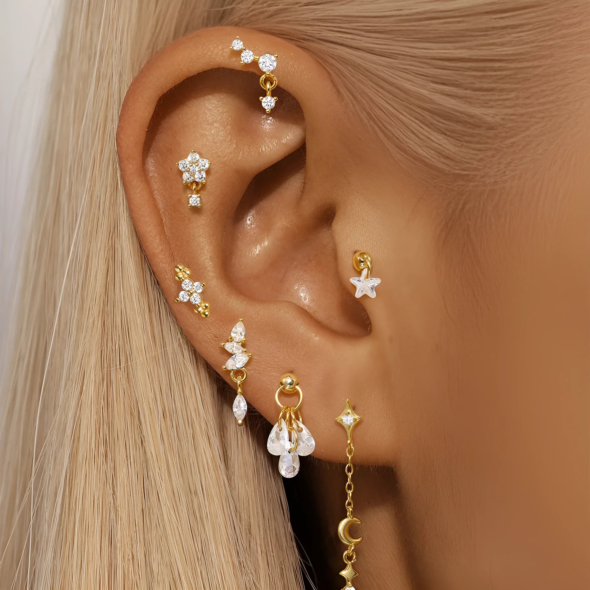 S925 sterling silver geometric star earrings with embedded moon and diamond detail in a gold colour.