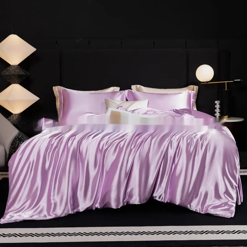 Solid colour silk bedding four-piece set shown in twilight blue on a bed.