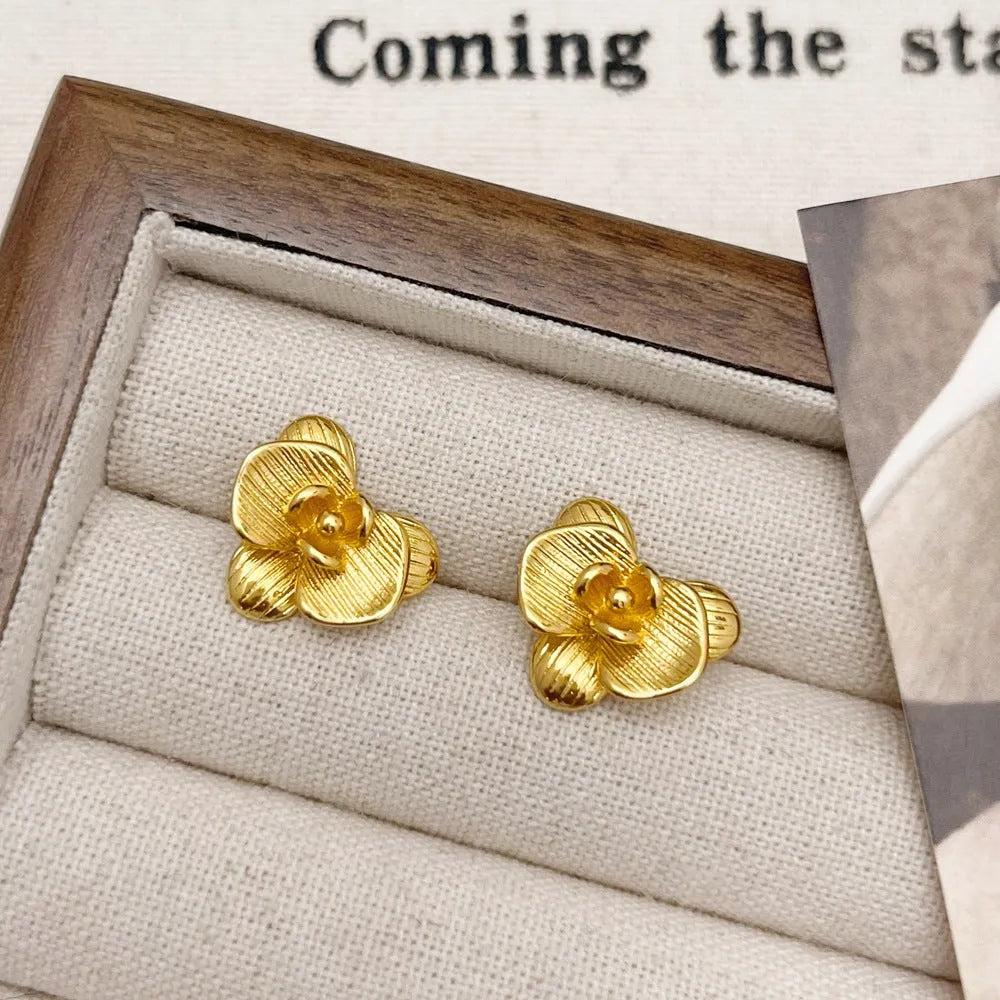 Retro flower fashion earrings in gold or silver electroplated finish with petal details