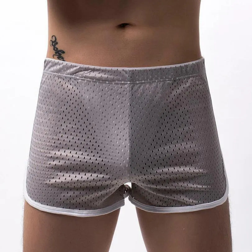 Men's black boxer shorts showing three-point ventilation panels and a mid-waist design.