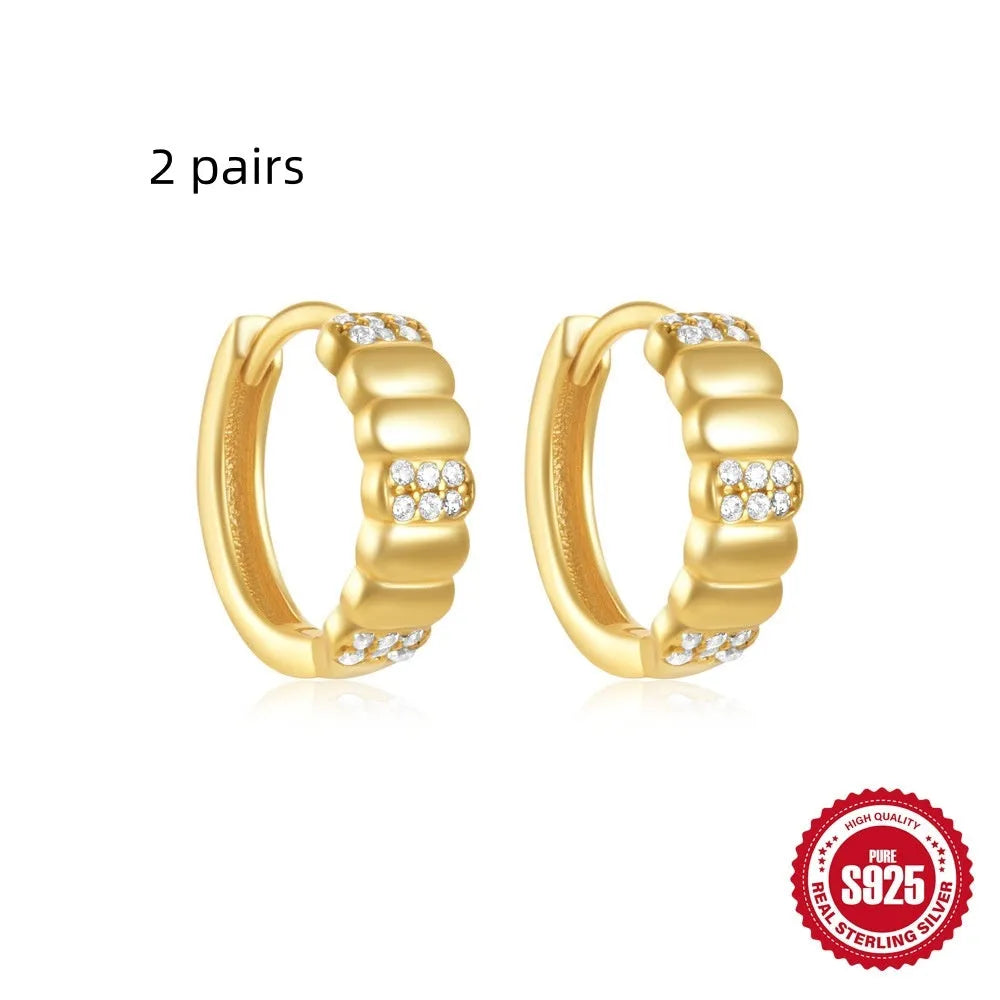 Small round geometric sterling silver stud earrings with a diamond shape, available in gold or silver finish.