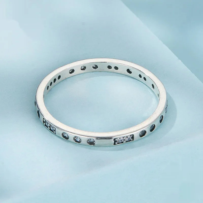 Women's oxidised black silver 'I Love You' ring with moss password design on a hand.