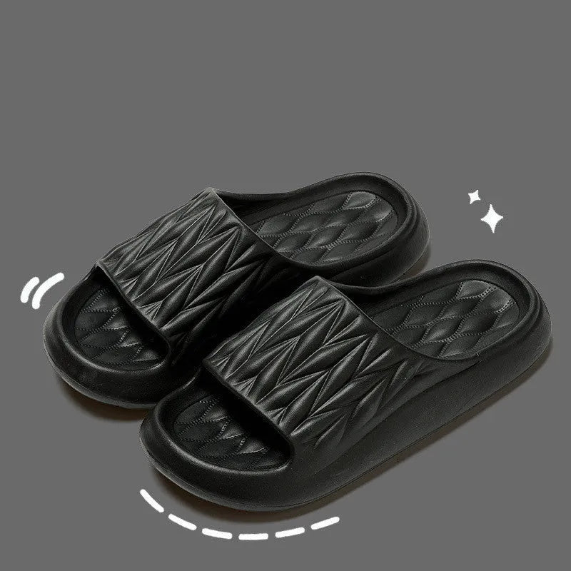 Pair of leaf-textured EVA indoor slippers on a solid background, showing non-slip sole.