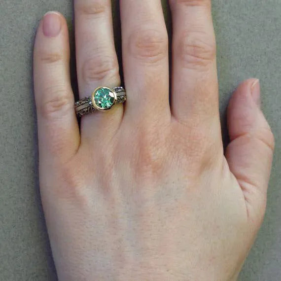 Vintage flower-shaped gemstone ring with gold plating and green silver colour finish showing colour separation design detail