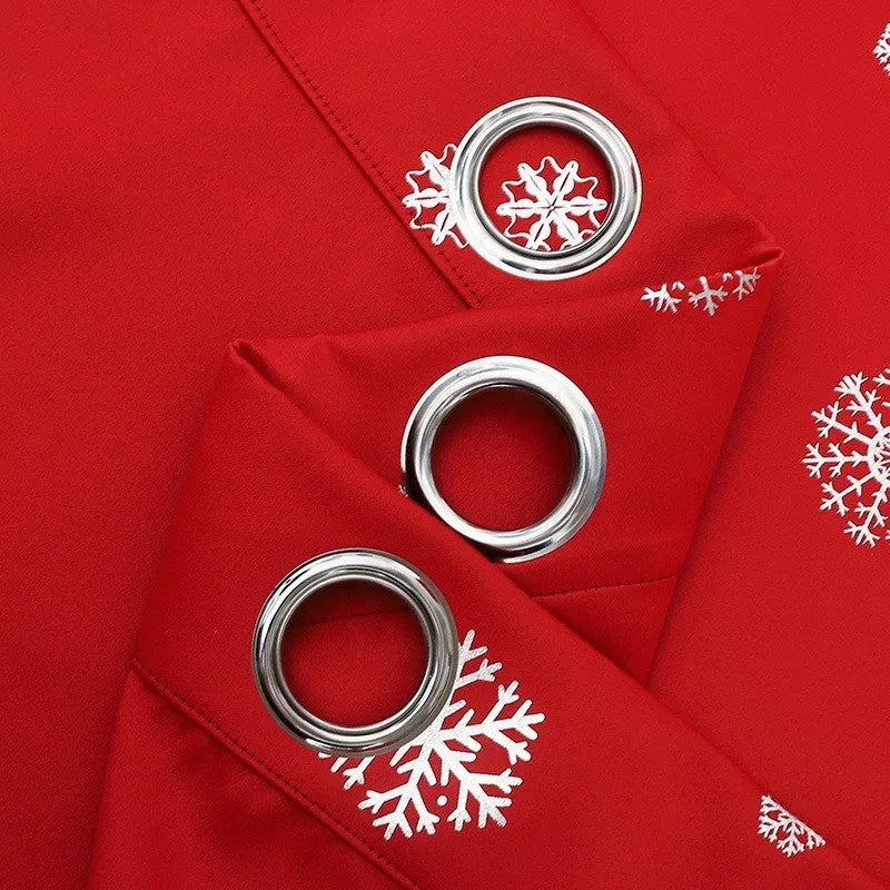 Red polyester snowflake pattern shade cloth curtain with lace loop trim hanging on a window