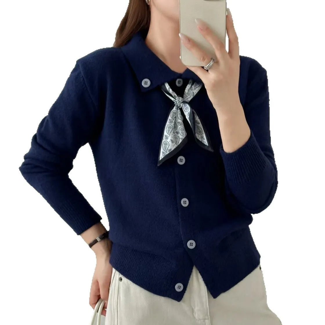 Women's beige lapel scarf collar acrylic cardigan sweater on a hanger.