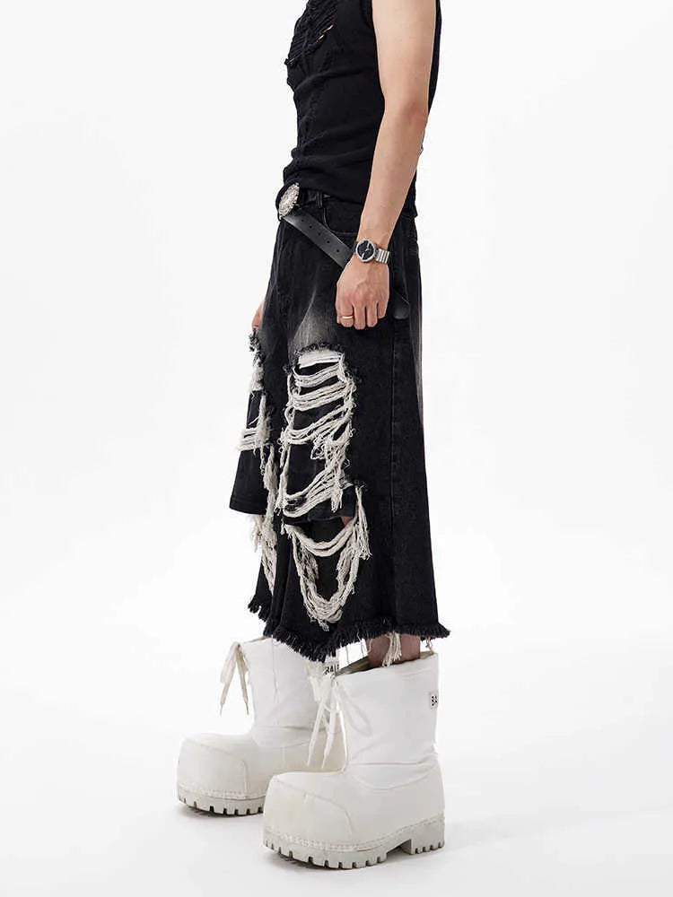 Black wide leg cropped jeans with mid-high waist and ripped patch detail on micro-elastic cotton denim