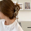 Korean style bow barrette with alloy metal construction in silver colour