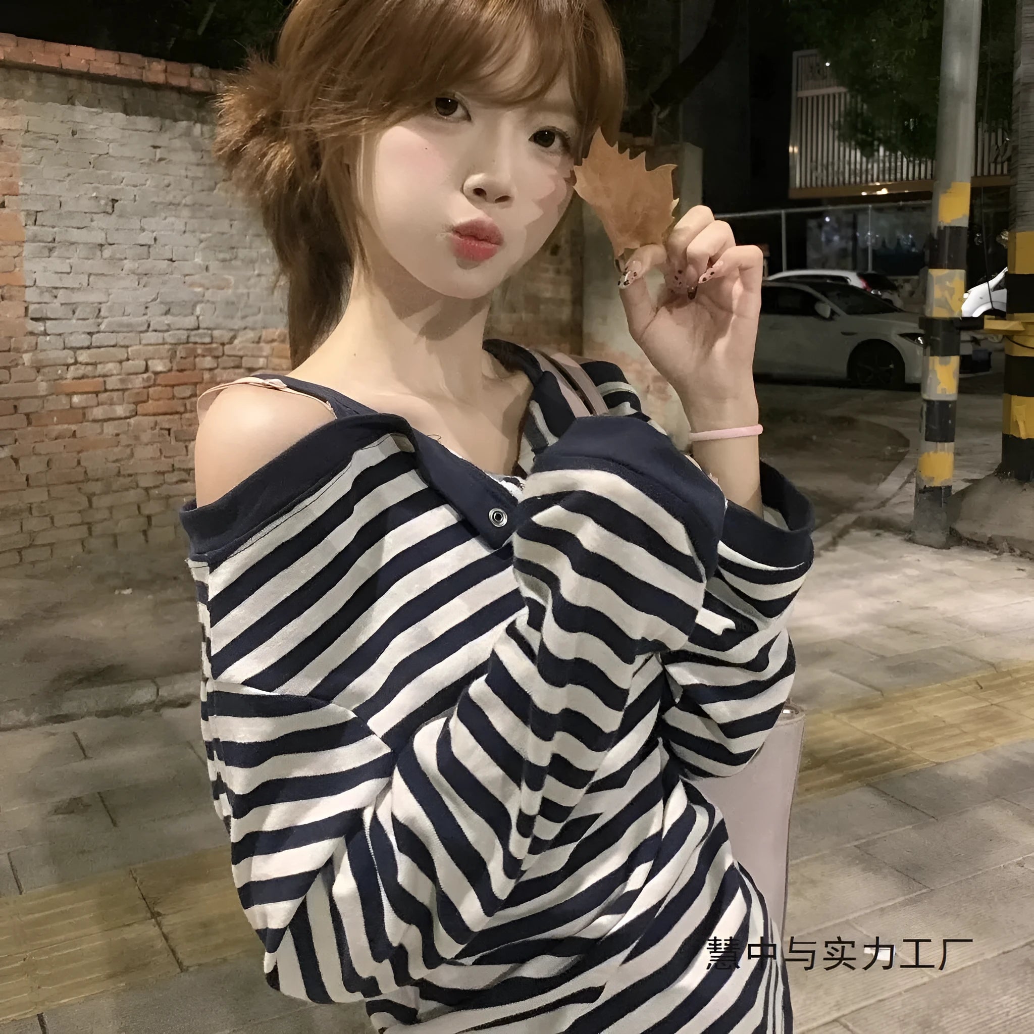 Dark blue Korean-style oversized women's long-sleeved t-shirt with embroidered stripes and button details.
