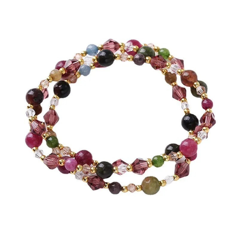 Women's adjustable three-ring crystal bracelet with tourmaline, strawberry quartz, and amethyst beads.