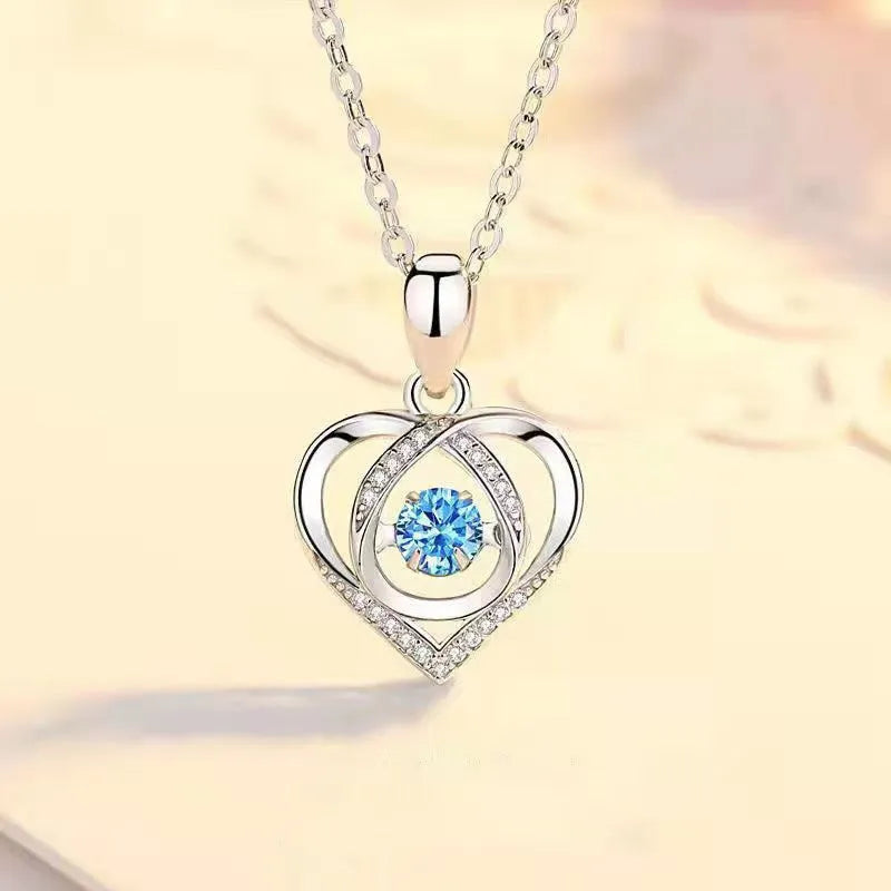 Blue diamond heart necklace and bracelet set with adjustable chain on display