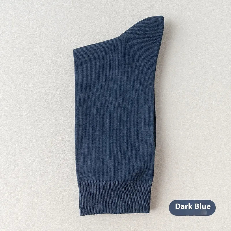 Men's solid colour pure cotton mid-calf business socks in beige, black, grey and blue shown folded.