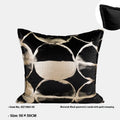 Black and gold abstract pattern flannel decorative cushion on a grey sofa.