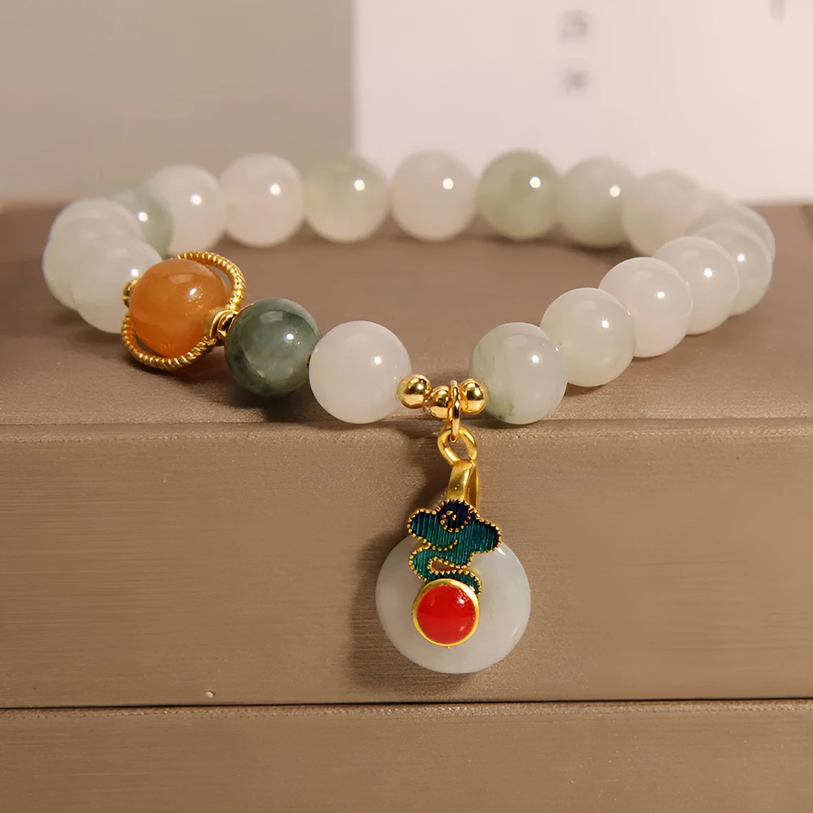 Women's ice jade bracelet with a pearl on the jade buckle.