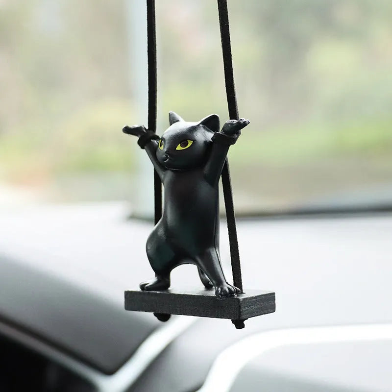 Cartoon style resin cat pendant on a rope for hanging in a car, shown in multiple colour options.