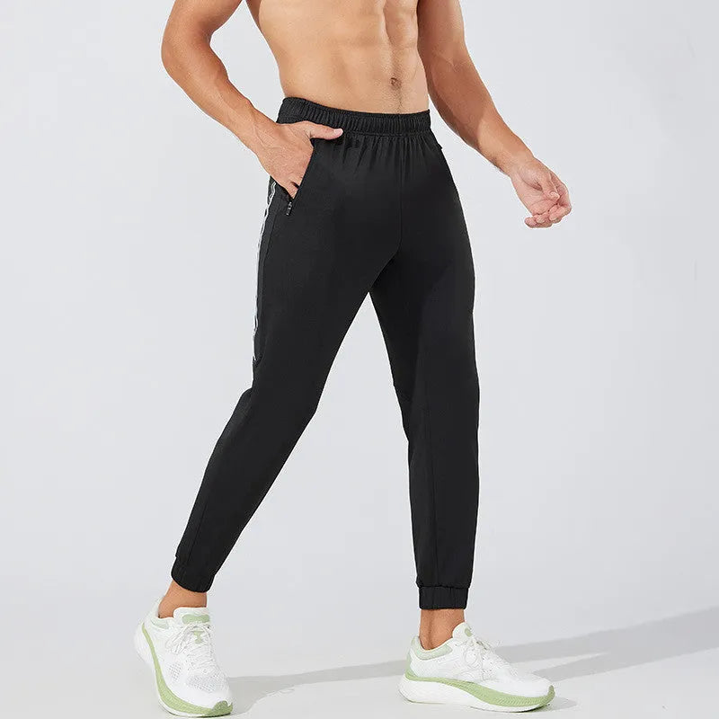 Men's black polyester running trousers with mid-waist design for exercise and sports activities