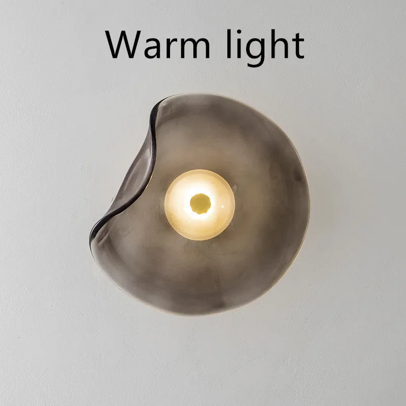 Round glass wall lamp in cognac colour with diffused lighting for bedroom bedside decoration
