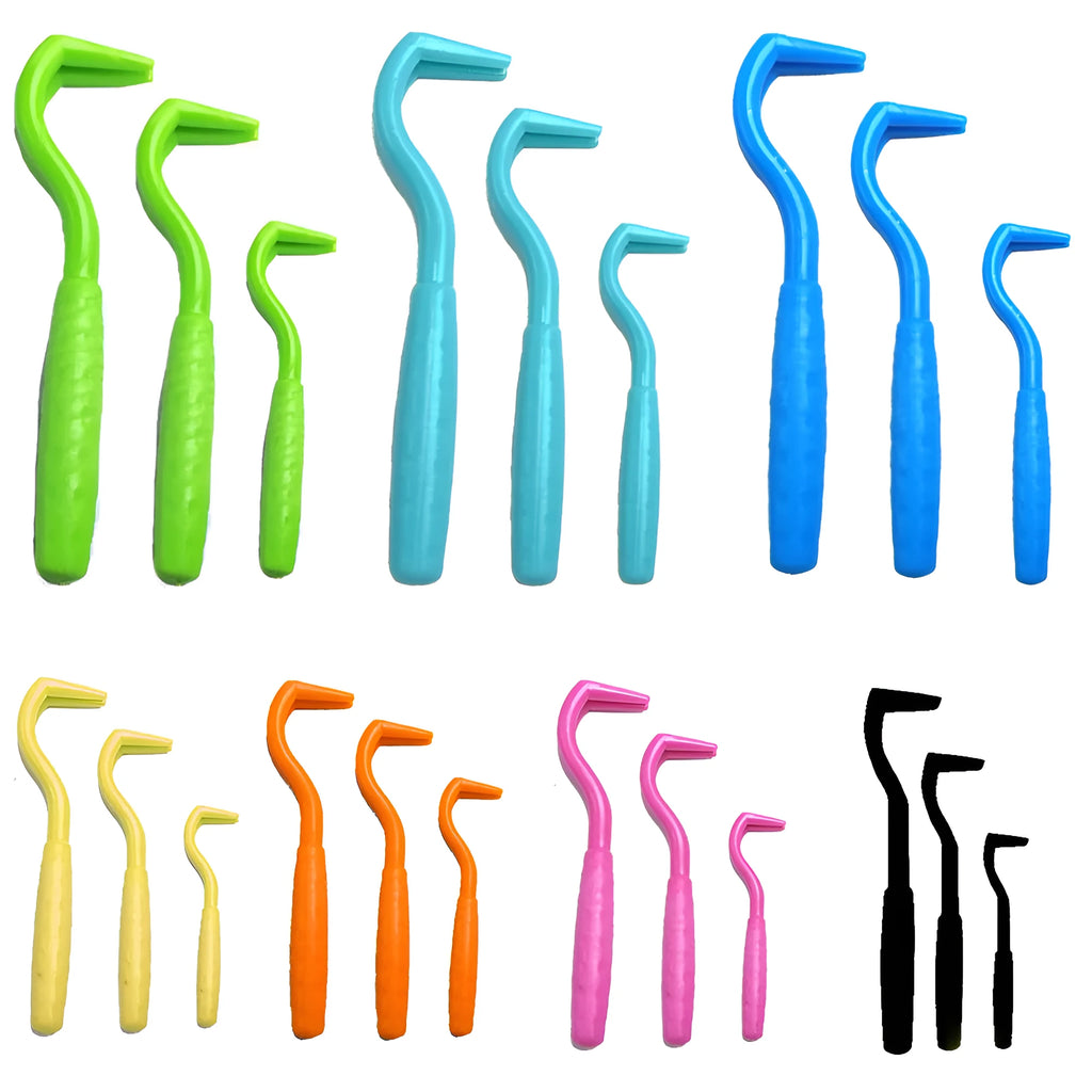 Set of three coloured ABS plastic tick removal hooks for dogs on a white background.