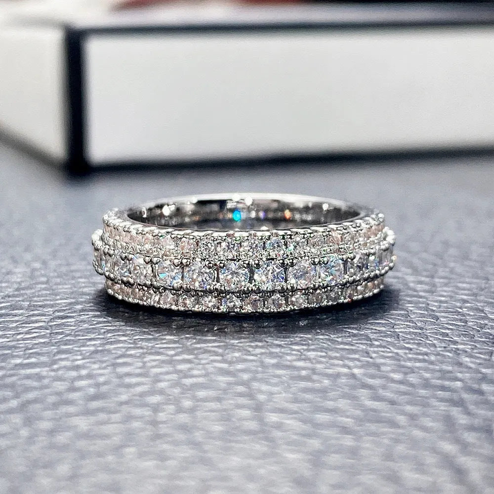 Geometric copper ring with triangular zircon stone, shown in white gold, yellow gold, and white and black finish options.