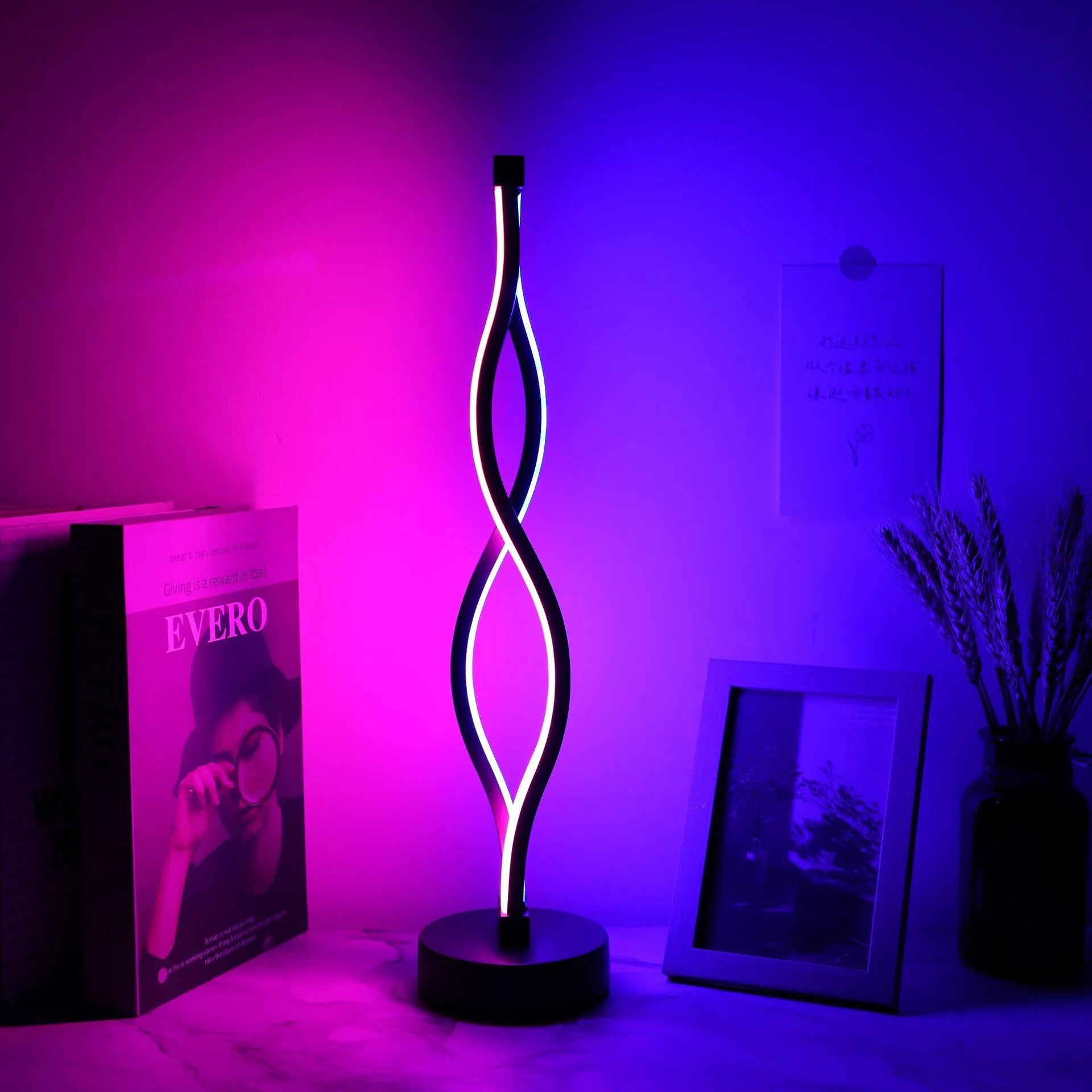Black aluminium desk lamp with touch dimming controls showing three colour temperature settings