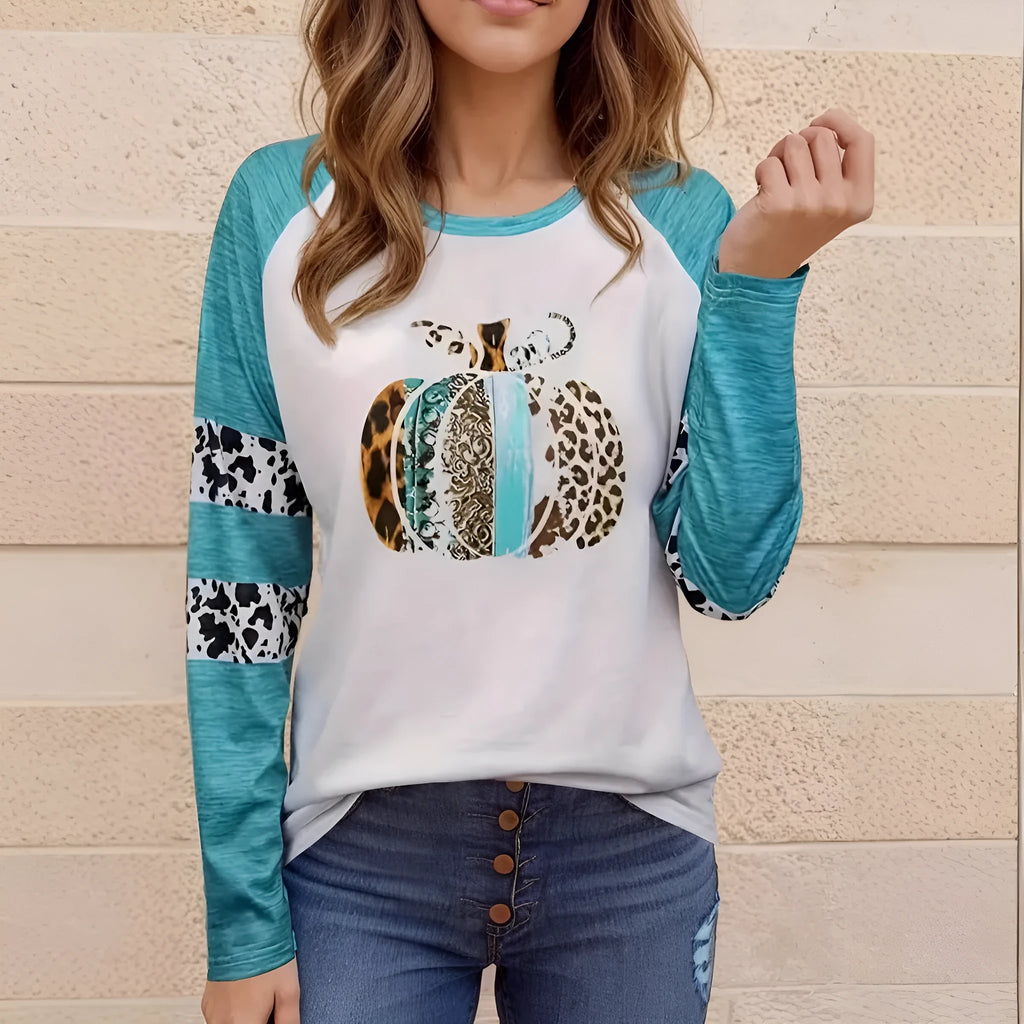 Sky blue Halloween t-shirt featuring a large white 3D digitally printed pumpkin design on the front.