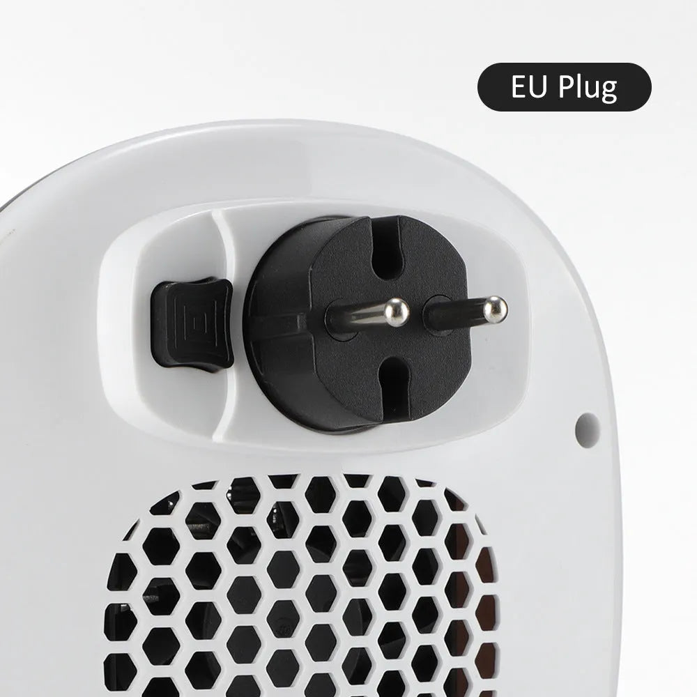 White ceramic heating electric blower with remote control on a desk.