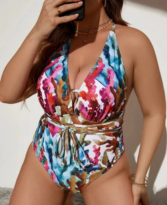 Solid blue halter neck one-piece swimsuit with brief-style bottoms on a mannequin.