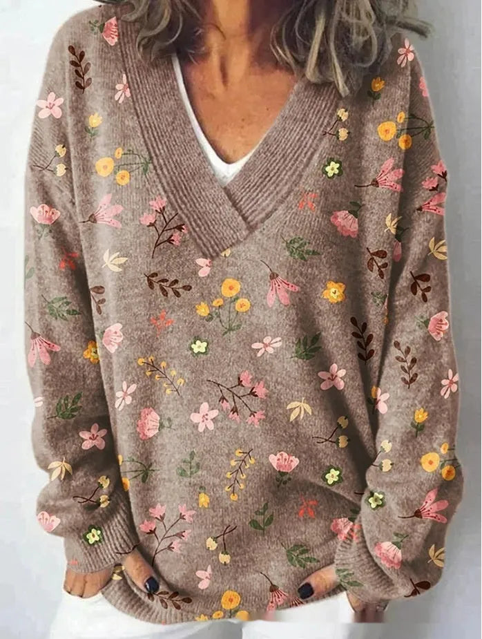 Women's white floral print V-neck sweatshirt with 3D pattern and long sleeves on a hanger.