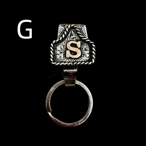 Handmade metal cow tag belt key holder keychain on a key ring, showing the metal loop and tag design.