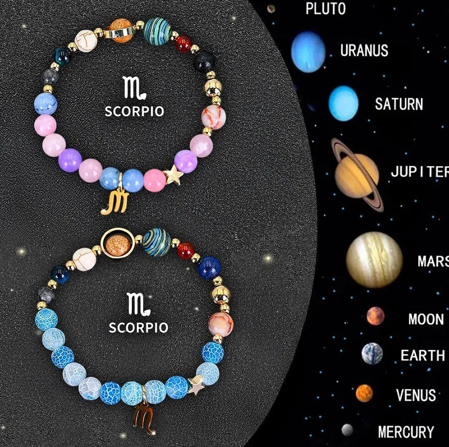Set of two natural stone beaded bracelets with zodiac sign charms on a white background.