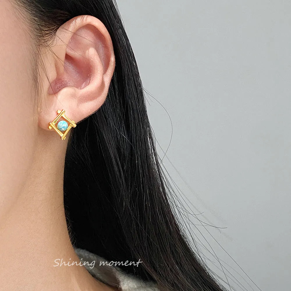 Women's geometric cross quadrangle stud earrings in sterling silver with gold or silver finish.