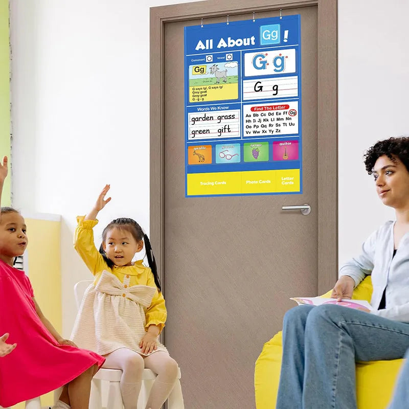 Blue alphabet learning sleeve table with word and letter cards laid out on its wipeable PVC surface.