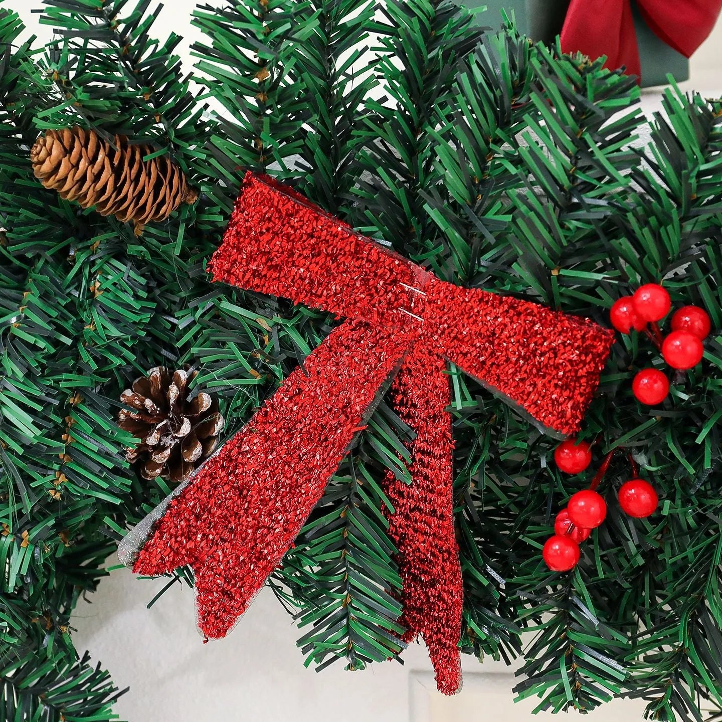 Christmas rattan pine cone bow decorative centrepiece with LED lighting on wooden table
