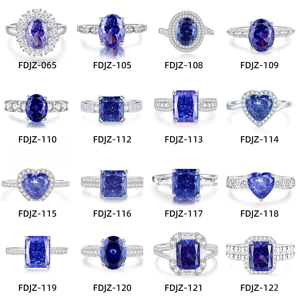 Heart shaped Tanzanite purple zircon ring in sterling silver on a grey background.