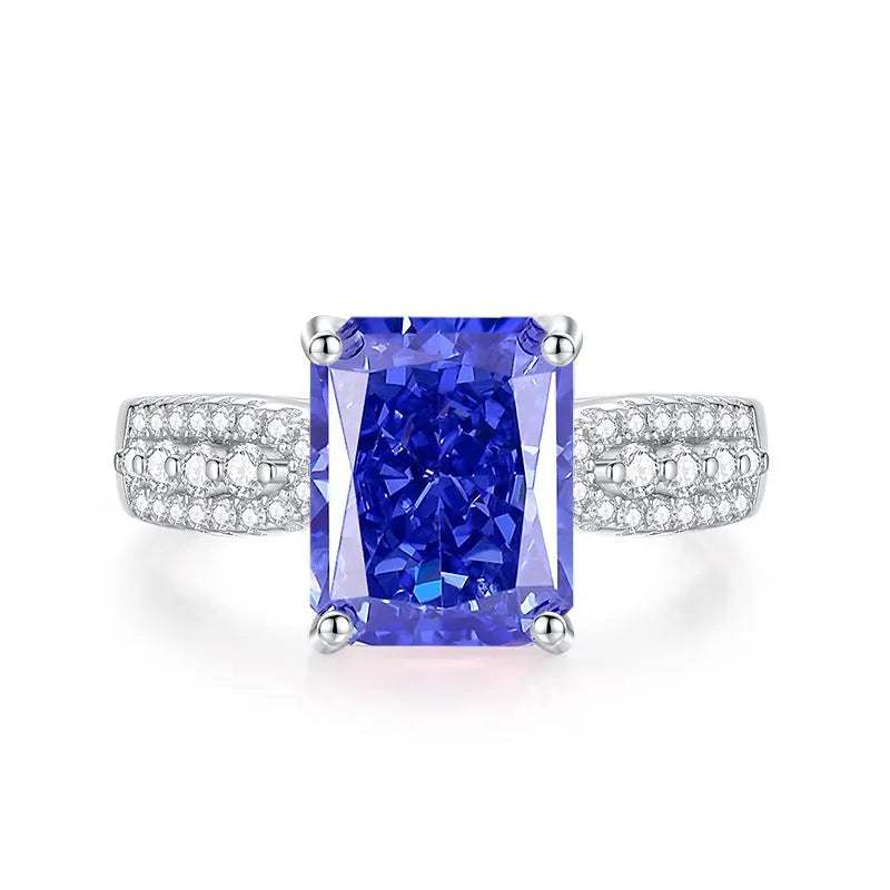 Heart shaped Tanzanite purple zircon ring in sterling silver on a grey background.