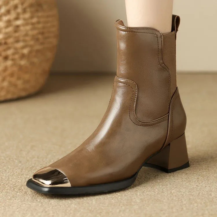 Women's brown cowhide leather Martin boots with a high heel and side zipper on a white background.