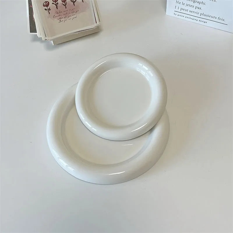 White porcelain plate with chubby toot or bear doodle pattern, shown in 15cm and 20cm round sizes.