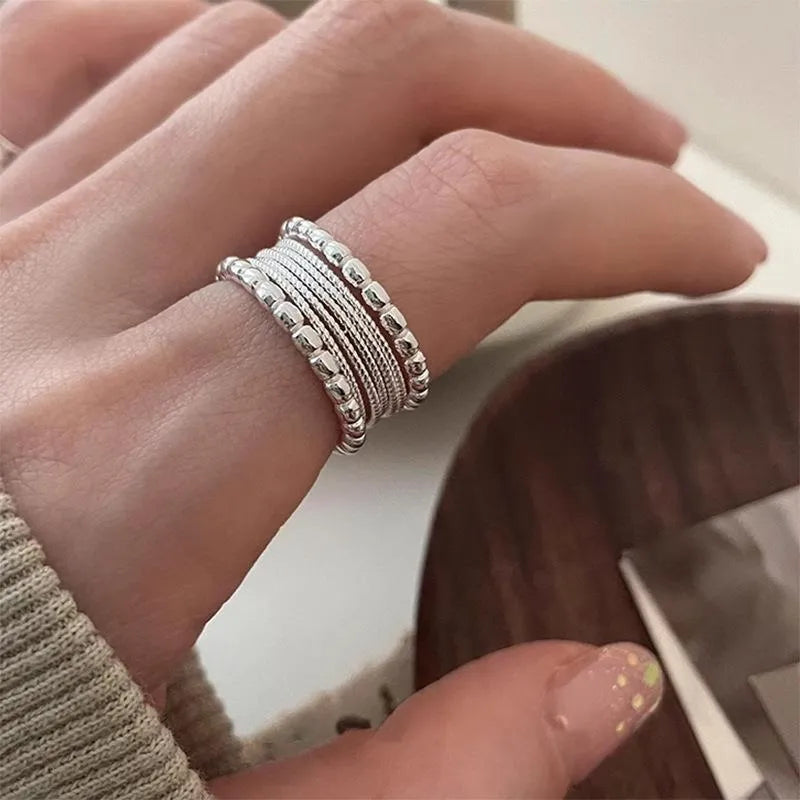 Geometric women's copper alloy ring with woven twisted design and adjustable opening