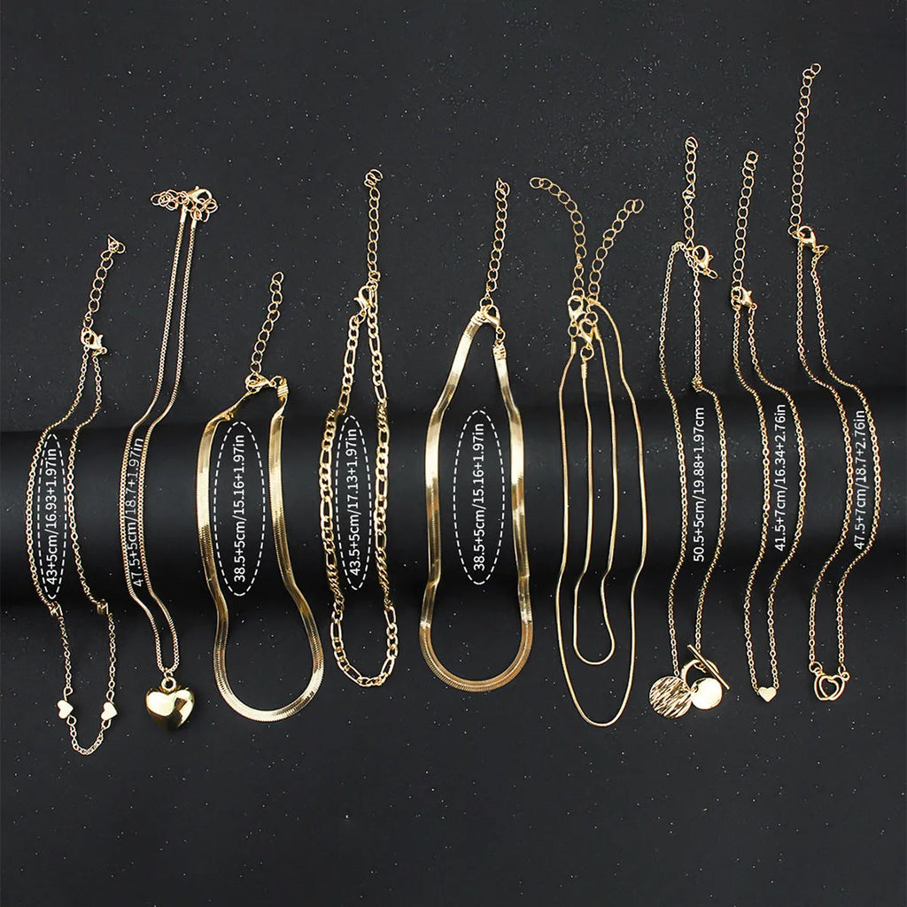 Gold-coloured women's necklace set showing ten pieces with simple alloy pendants on snake bone chains