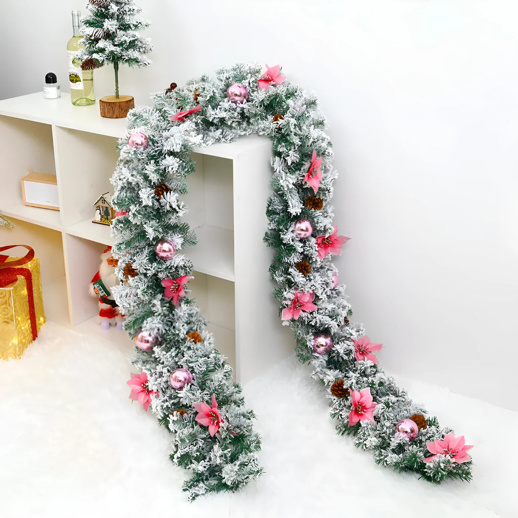 Snow-flocked Christmas rattan garland vine in red, draped on a mantelpiece.