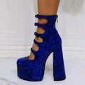 Women's black patent leather platform high heel boots with a thick heel and serpentine ankle buckle.