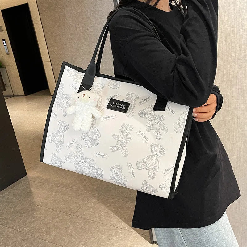 Canvas tote bag with rhombus pattern design showing sandwich pocket and shoulder strap