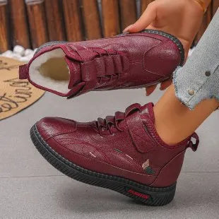 Women's black velvet house shoes with a hollow-out design and non-slip rubber sole.