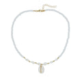 White conch shell pendant and bead necklace on a regular chain.