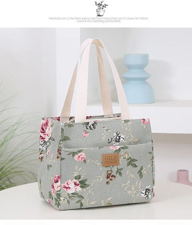 Women's printed canvas handbag with aluminium frame in square horizontal design showing floral pattern